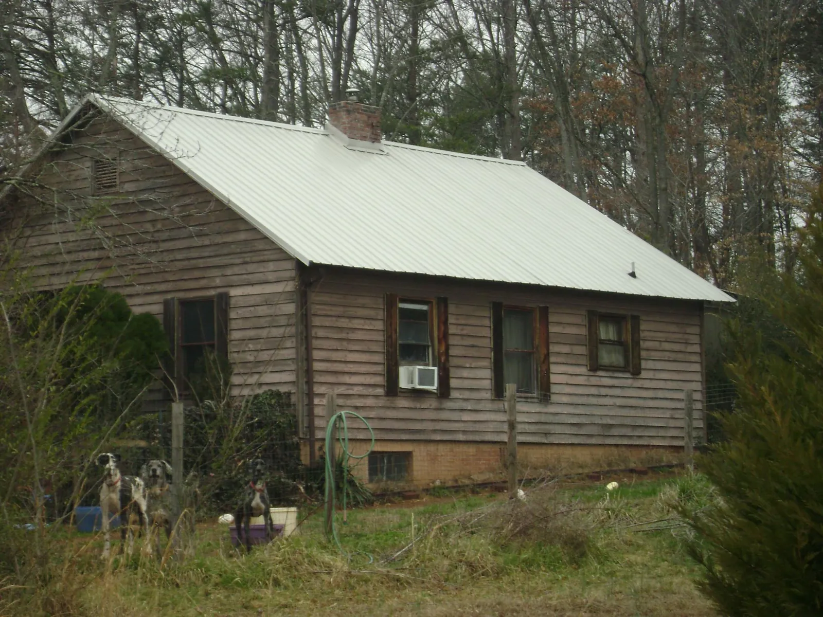White metal roof on an old wood sided farmhouse, from a Metal Roof Installation job in Millen